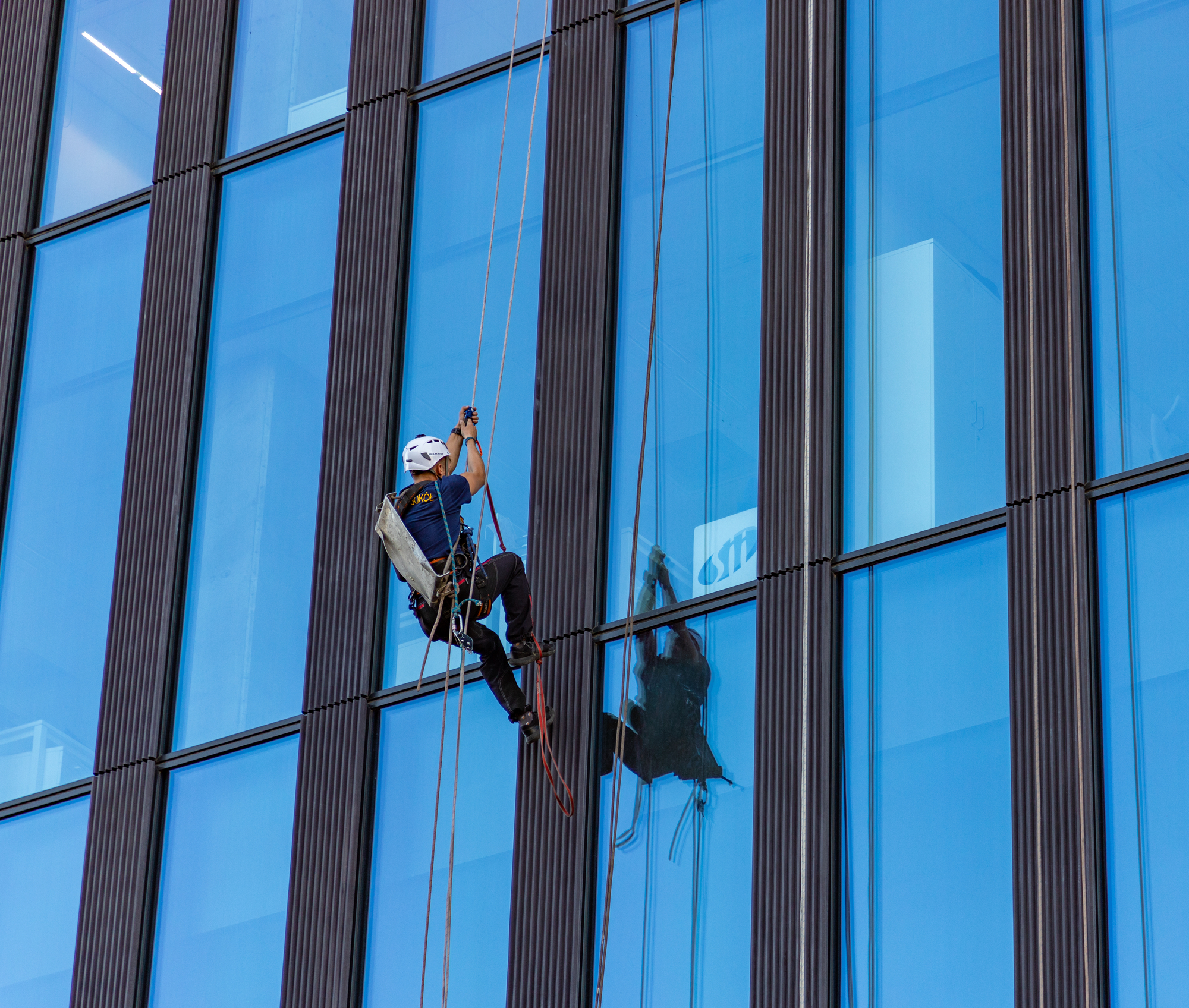 Office Building Cleaner A picture of a window cleaner climbing an office building.
