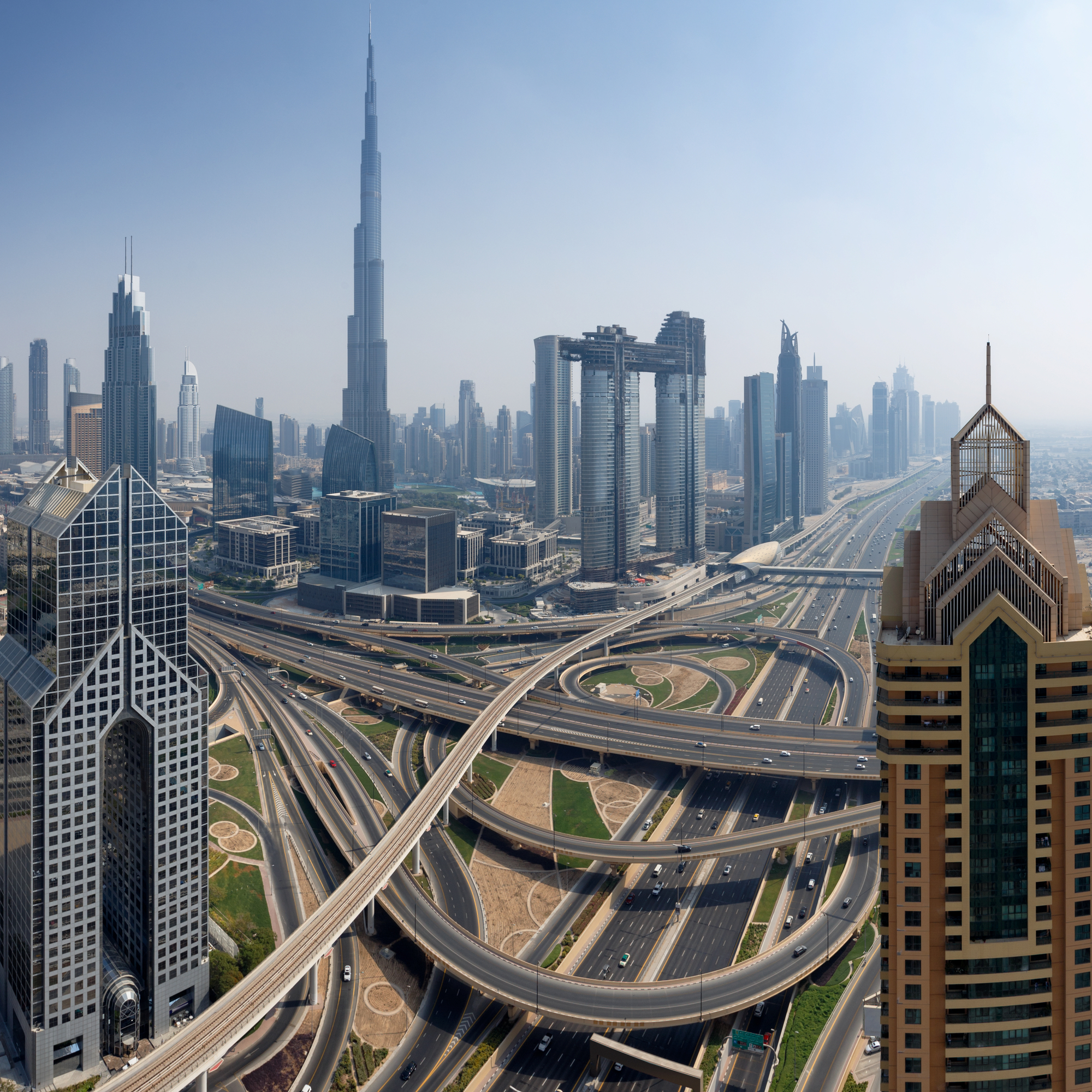 Dubai skyline, aerial top view to downtown city center landmarks. Famous viewpoint, United Arab Emirates A picture of a window cleaner climbing an office building.
